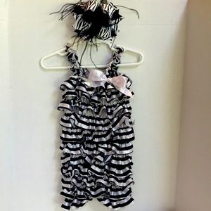 New never used ruffle romper suitable for a 18-24 months plus beautiful hair bow